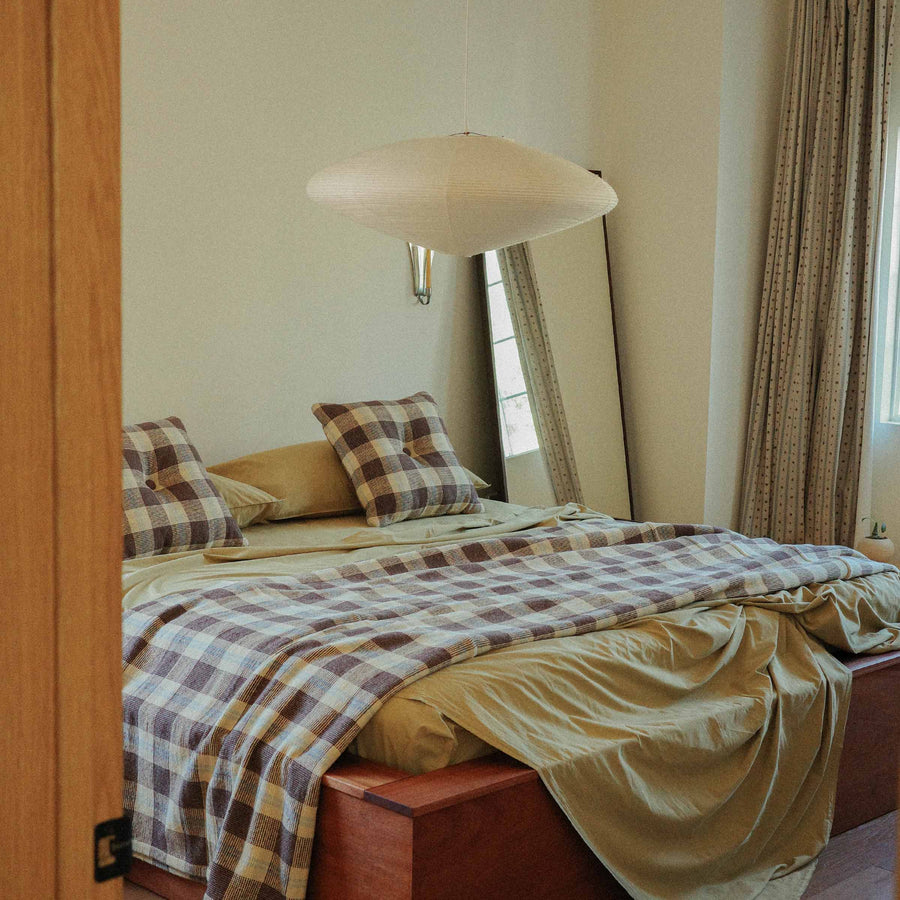 Morrow Soft Goods Pairing Mina Coverlet and Throw Pillows with Organic Percale Sheets in Pale Olive -bedroom lifestyle image.