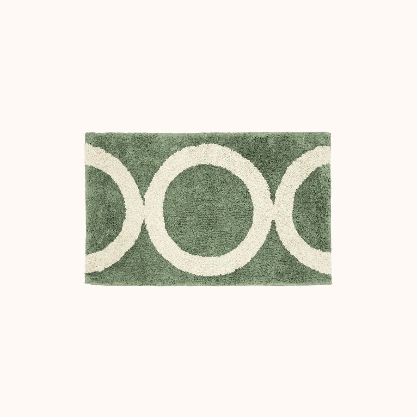 A green and beige geometric designed bath mat.