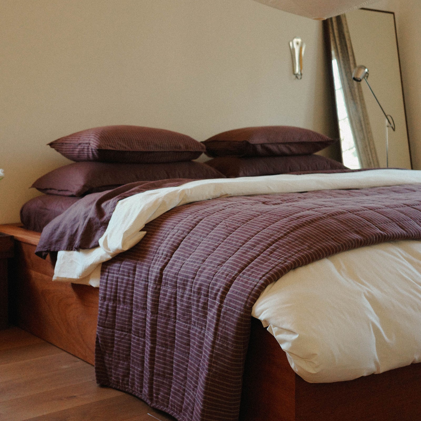 Morrow Soft Goods Pairing of Juno Check Quilt with Hemp Cotton Sheets in Brun and Duvet Cover in Oat - bedroom lifestyle image