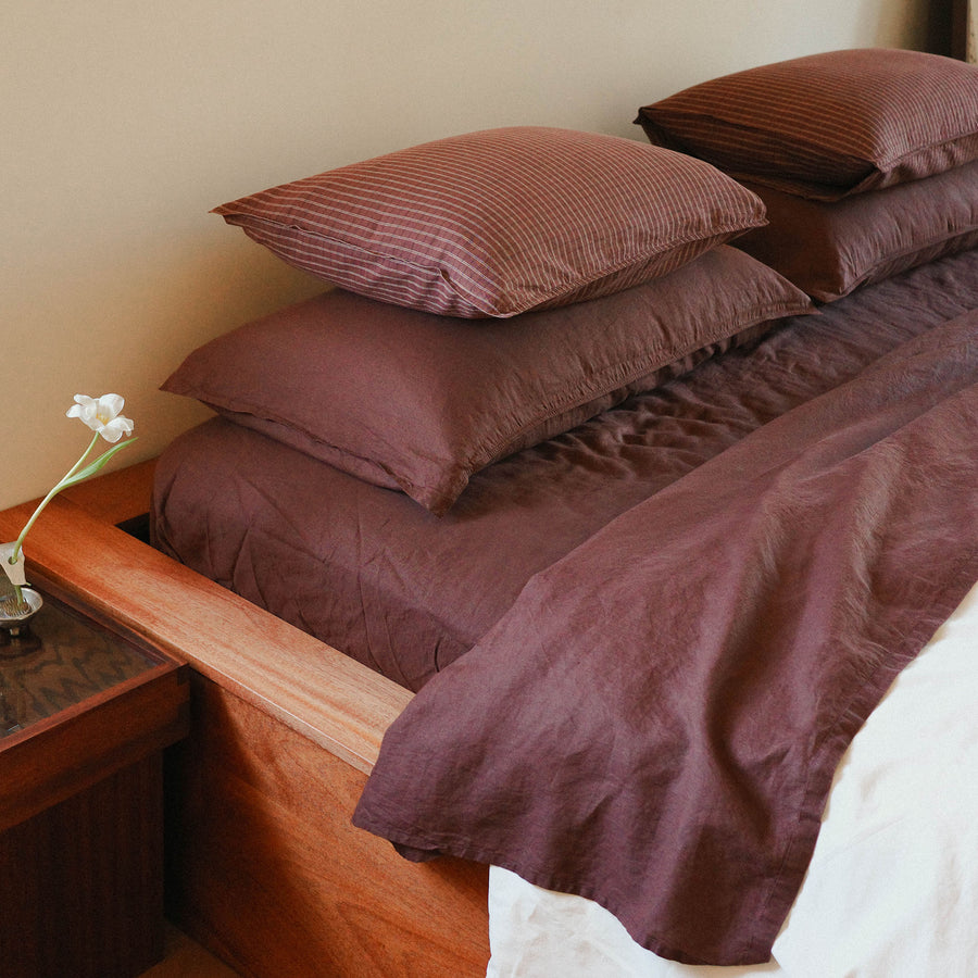 Morrow Soft Goods Pairing of Juno Check Pillowcases with Hemp Cotton Sheets in Brun and Duvet Cover in Oat - close lifestyle image