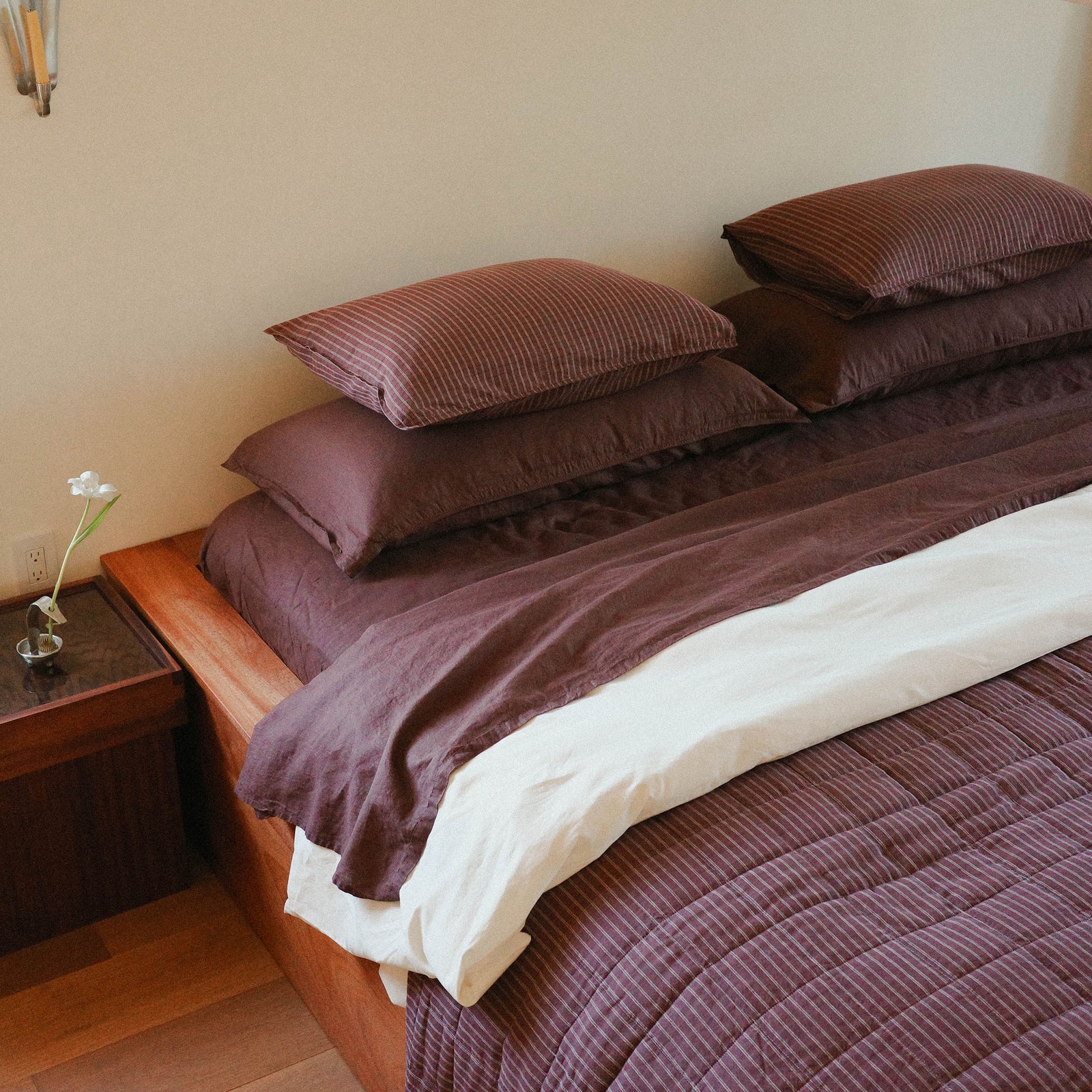 Morrow Soft Goods Pairing of Juno Check Quilt with Hemp Cotton Sheets in Brun and Duvet Cover in Oat - bedroom lifestyle image