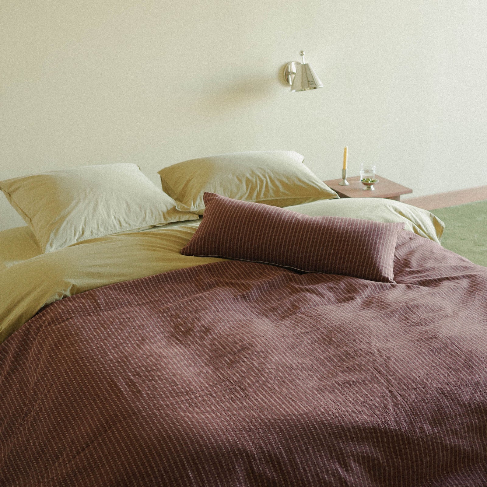 Morrow Soft Goods Juno Check Duvet and Lumbar with Organic Percale Sheets in Pale Olive bed lifestyle image