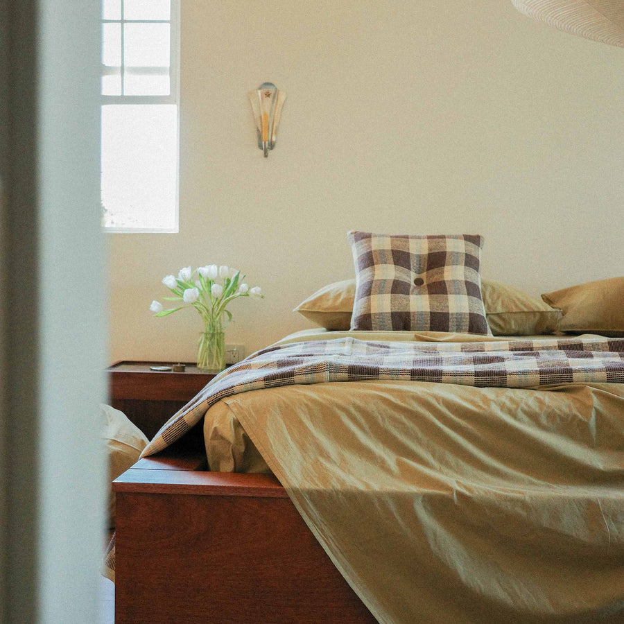Morrow Soft Goods Pairing Mina Coverlet and Throw Pillow with Organic Percale Sheets in Pale Olive -bedroom lifestyle image.
