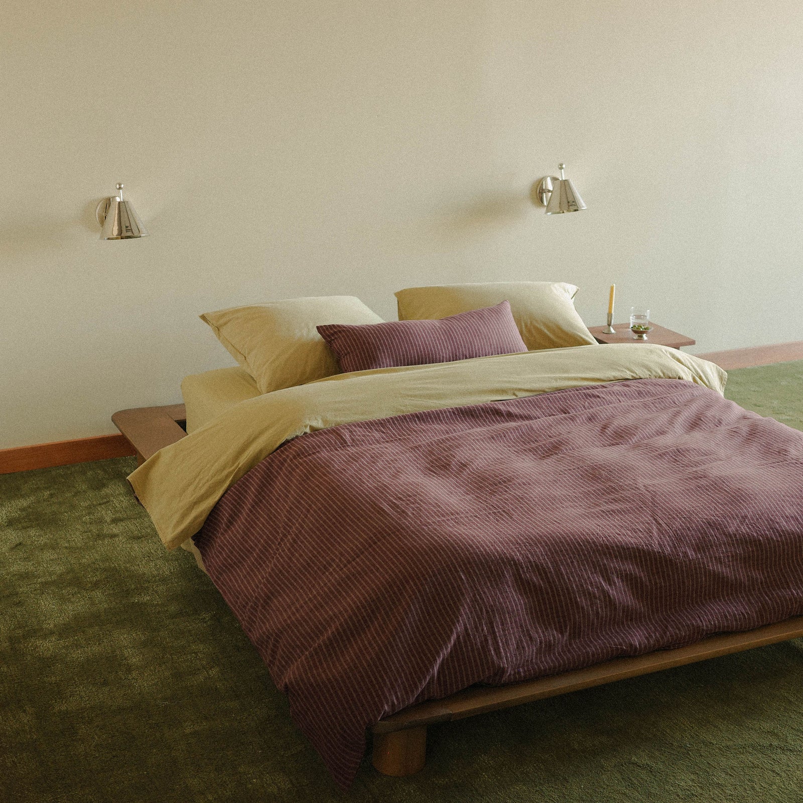 Morrow Soft Goods Juno Check Duvet and Lumbar with Organic Percale Sheets in Pale Olive lifestyle image with green carpet