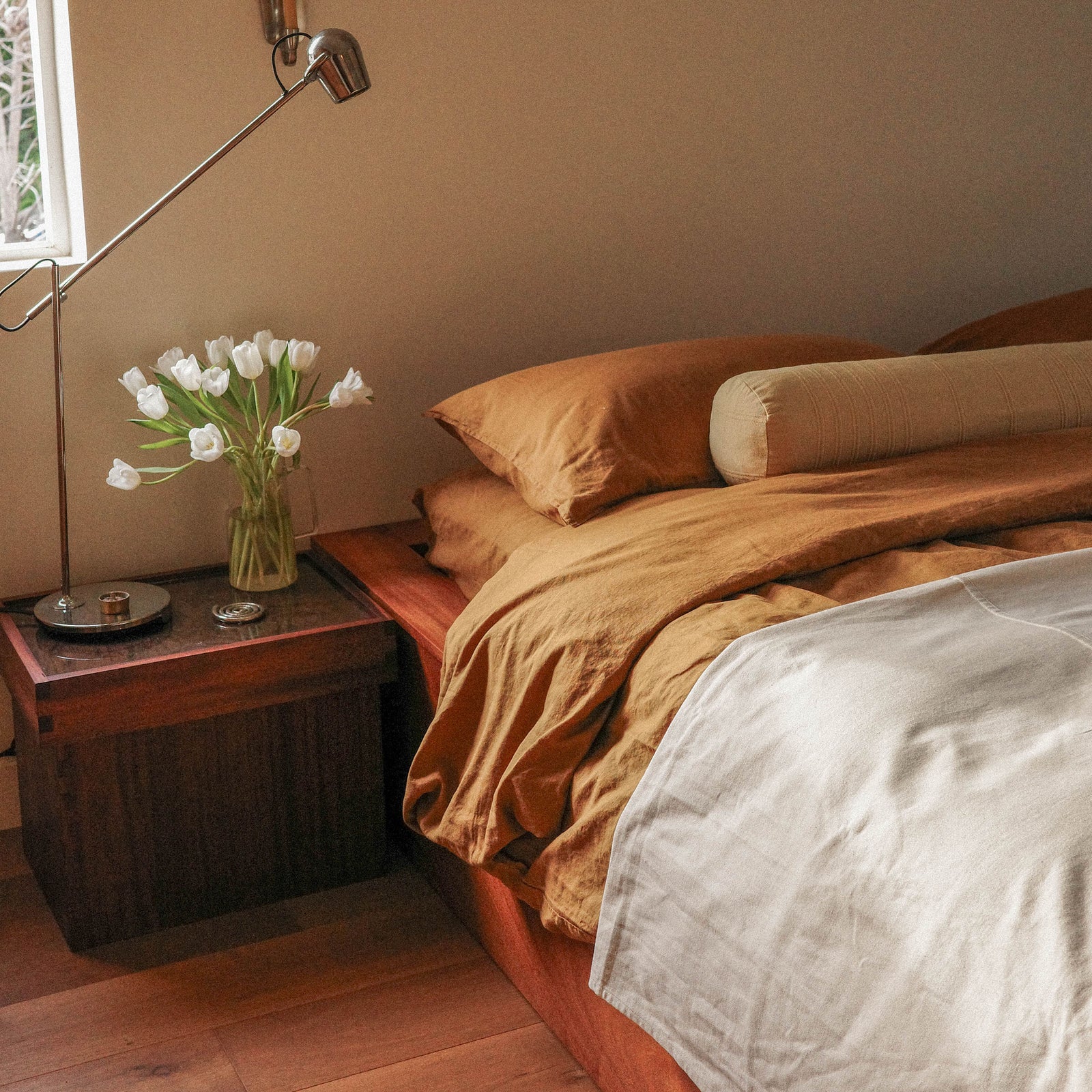 Morrow Soft Goods Hemp Cotton Duvet Cover in Willow, Marta Coverlet in White and Devi Bolster in Maiz. Bedroom Lifestyle Image 