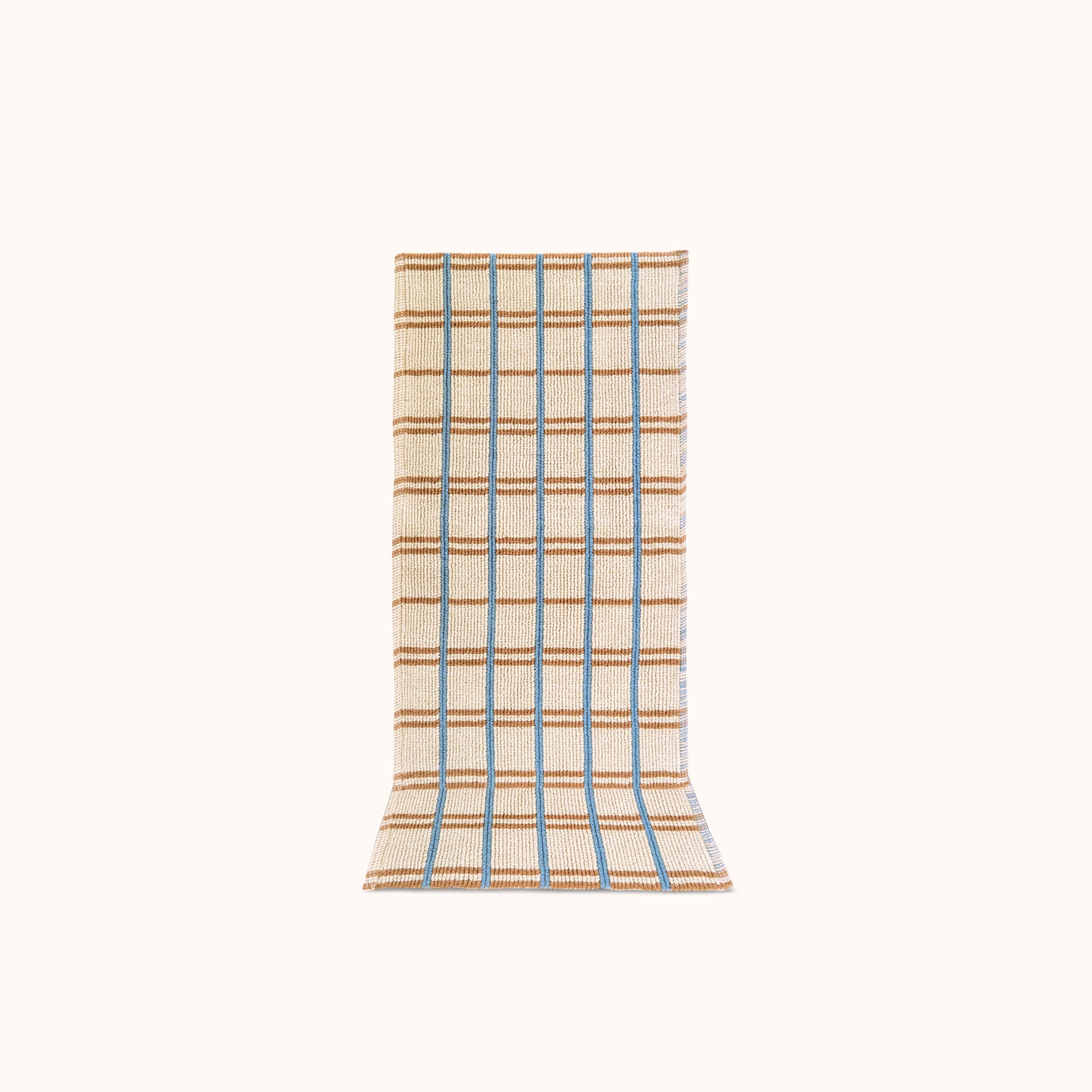 A rectangular, runner with a geometric checkered pattern in blue and tan on a natural beige background, designed for use as a kitchen or bath mat.