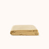 Folded yellow flat sheet on a white background
