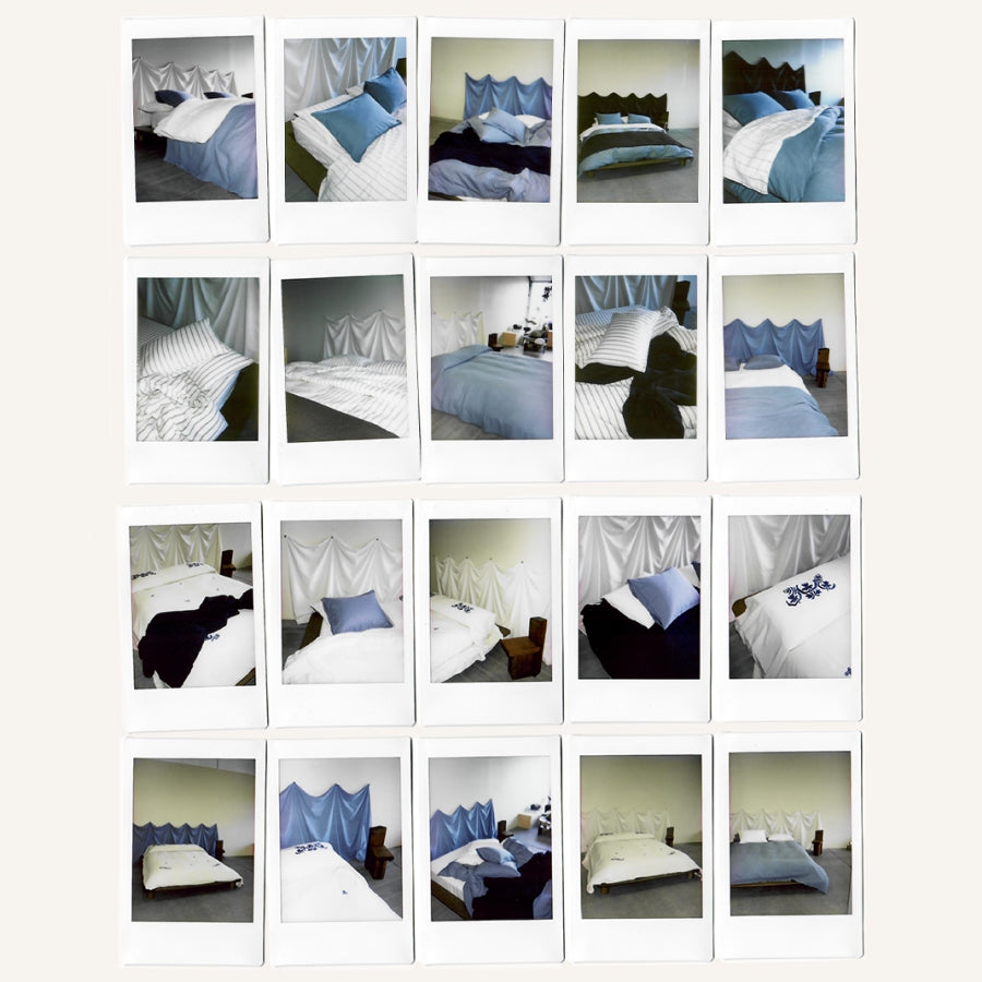 A collage of 20 Polaroid photos arranged in a grid, each showing different bedroom scenes with white, blue, and dark navy beddung.