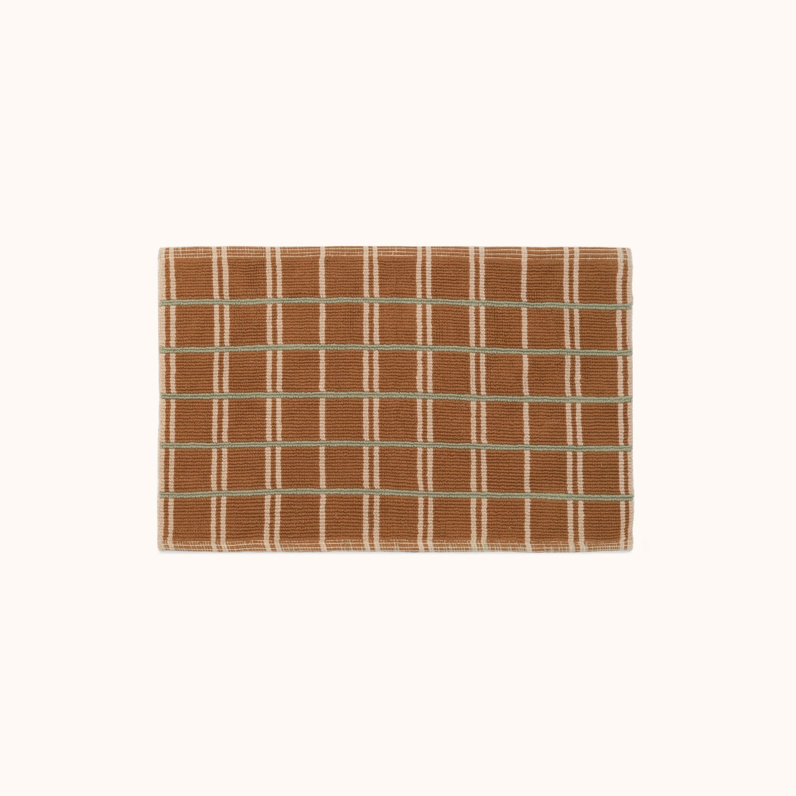 A brown bathmat with horizontal green stripes and vertical tan stripes on a white background.