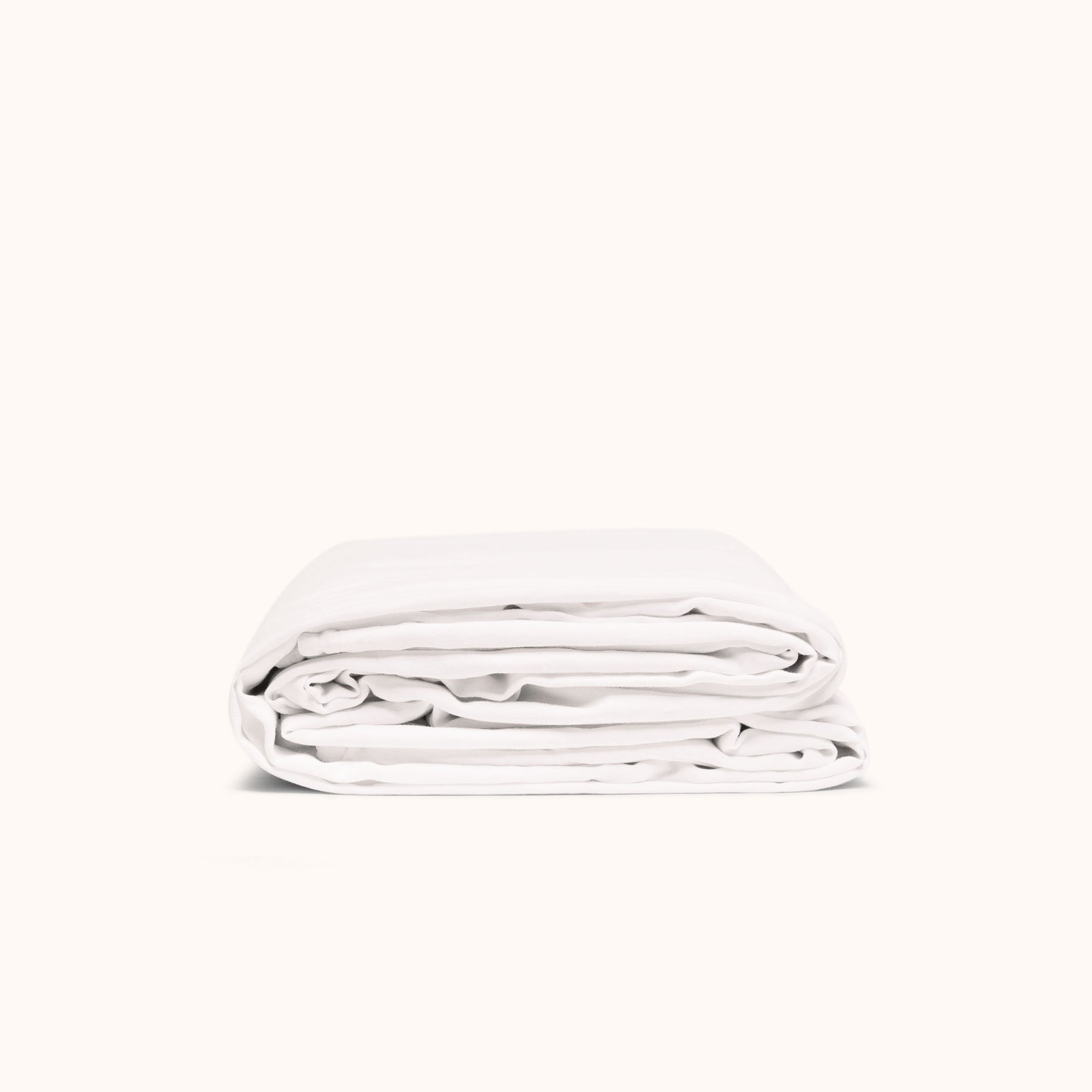 A folded white duvet cover made of matte sateen, displayed against a white background.
