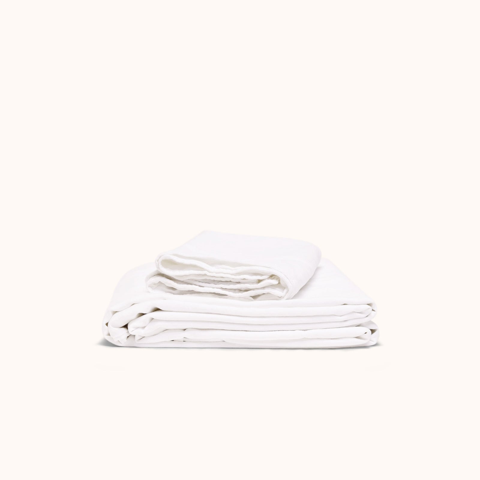A folded white matte sateen sheet set on a white background